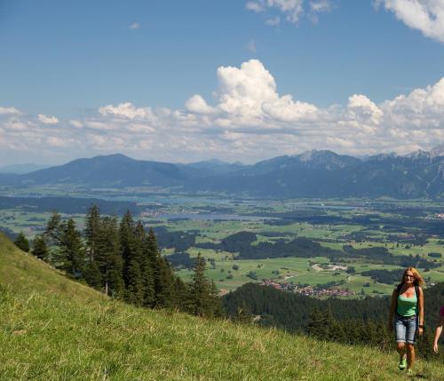 a group of people walking up a hill at Hotel Gasthof Post in Nesselwang