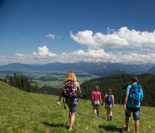 a group of people walking up a hill at Hotel Gasthof Post in Nesselwang