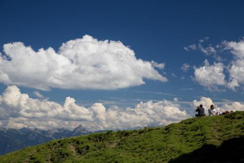 a group of people sitting on top of a hill at Hotel Gasthof Post in Nesselwang