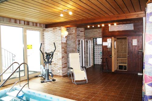 a room with a swimming pool and a gym at Haus Vierjahreszeiten in Reit im Winkl