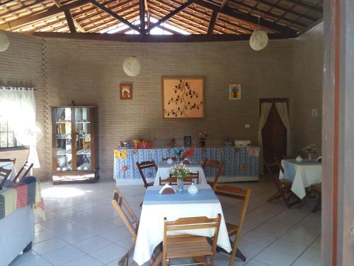 a dining room with a table and chairs in it at Pousada Recanto do João de Barro in Conservatória