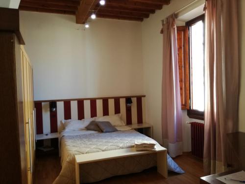 a bedroom with a bed and a table in it at La casa di Simona in Pistoia