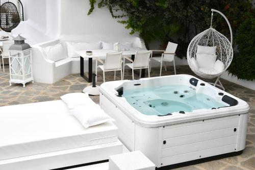 a jacuzzi tub in the middle of a patio at Paros Butterfly Villas in Pounda