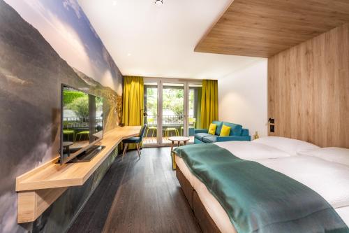a hotel room with a bed and a tv at Hotel sleep&stay - Self Check-in in Eglisau