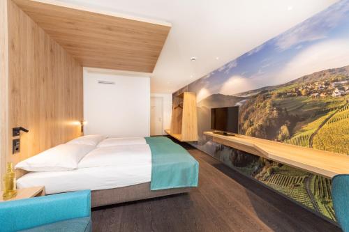 a bedroom with a bed and a painting on the wall at Hotel sleep&stay - Self Check-in in Eglisau