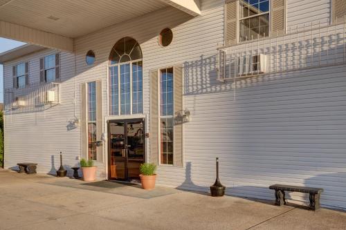 a building with a door and benches in front of it at Howard Johnson by Wyndham Branson Theatre District in Branson