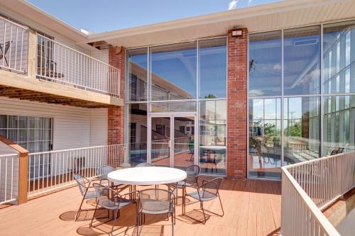 a patio with a table and chairs on a balcony at Howard Johnson by Wyndham Branson Theatre District in Branson