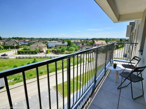a balcony with chairs and a view of a street at Presto by Housine,pl Zator in Zator