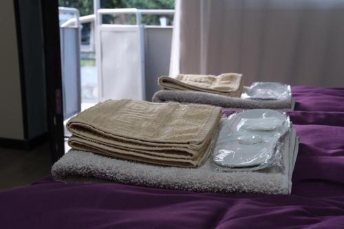 a pile of towels sitting on top of a bed at BMG (Be My Guest) in Mtskheta