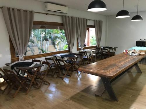 a room with tables and chairs and a large wooden table at Hotel Luz in Fronteira