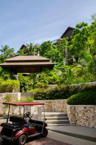 a golf cart parked in front of a building at Kirikayan Residences Koh Samui in Mae Nam