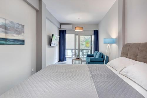 - une chambre avec un lit blanc et une chaise bleue dans l'établissement Brand new apartment in the heart of the city, à Athènes