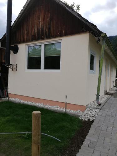 a white building with windows on the side of it at Ferienhaus Am-moore in Steindorf am Ossiacher See