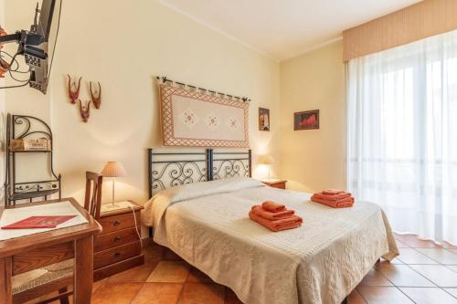 a bedroom with a bed with two towels on it at Il Leccio in Tortolì