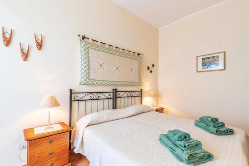 a bedroom with a bed with two towels on it at Il Leccio in Tortolì