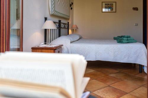 a room with two beds and a table and a lamp at Il Leccio in Tortolì