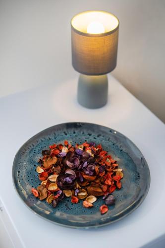 a plate of food on a table next to a candle at B&B PROCHYTEA in Procida