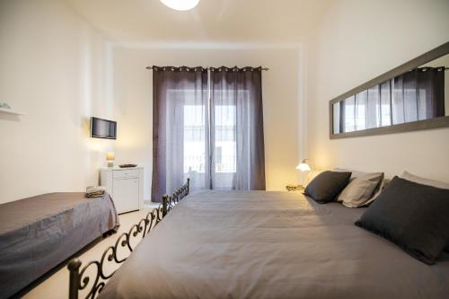 a bedroom with a large bed and a window at B&B PROCHYTEA in Procida