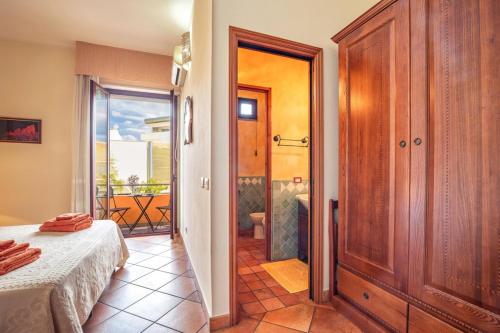 a bedroom with a bed and a door to a balcony at Il Leccio in Tortolì