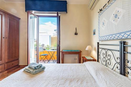 a bedroom with a bed and a large window at Il Leccio in Tortolì