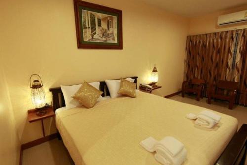 Postel nebo postele na pokoji v ubytování Baanmalai Hotel Chiangrai