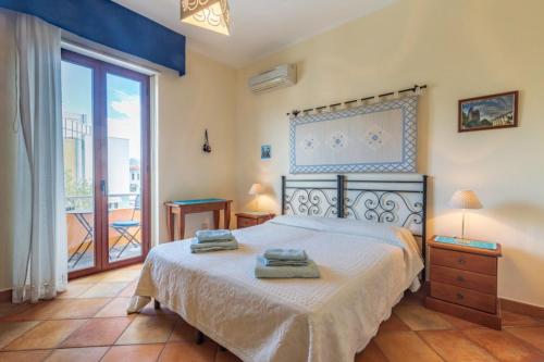 a bedroom with a bed with two towels on it at Il Leccio in Tortolì
