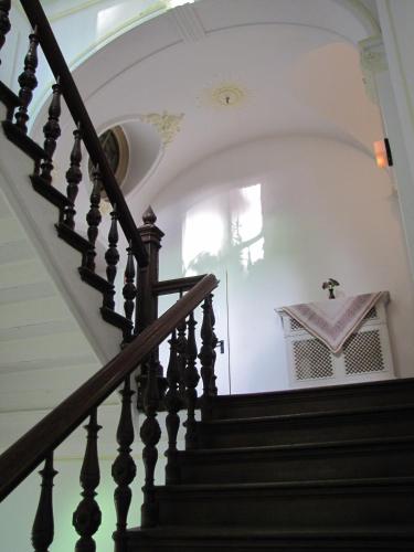 a staircase in a house with a cross on the wall at Haus Annaberg in Bonn