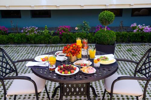 a table topped with plates of food and drinks at Amante Narikala by Tbilisi Luxury Boutique Hotels in Tbilisi City