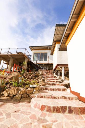 a home with a stone staircase leading to a house at Native Residence in Rosarito
