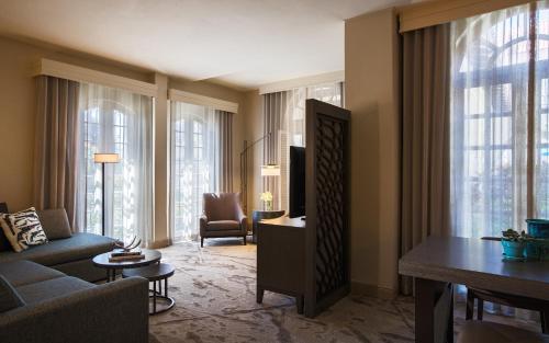 a living room with a couch and a tv at Casa De Palmas, Trademark Collection by Wyndham in McAllen
