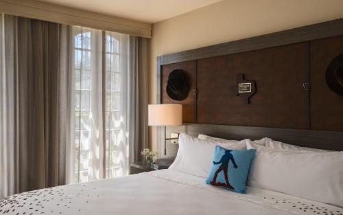 a bedroom with a bed with a blue bow on the pillow at Casa De Palmas, Trademark Collection by Wyndham in McAllen