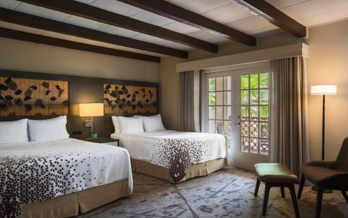 a hotel room with two beds and a window at Casa De Palmas, Trademark Collection by Wyndham in McAllen