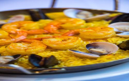 a tray of food with shrimp and oysters on rice at Casa De Palmas, Trademark Collection by Wyndham in McAllen