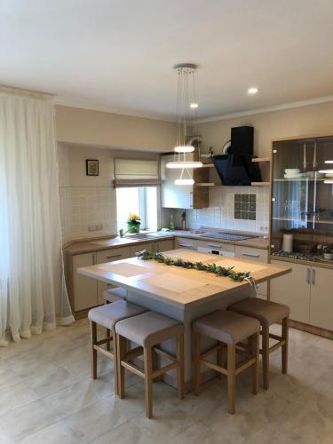 a kitchen with a large wooden table and chairs at Сонячне Закарпаття in Polyana