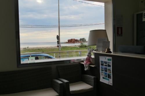 a room with a window with a view of the beach at Hotel Celeste in Marzamemi