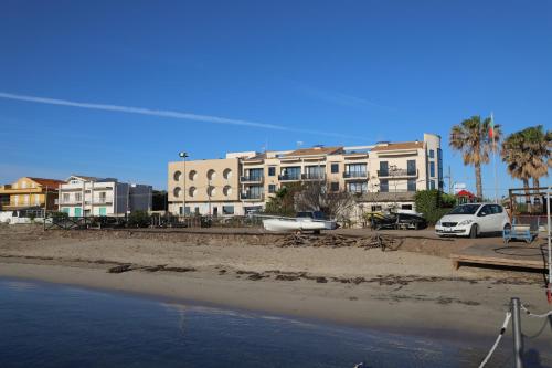 a view of a beach with buildings in the background at Hotel Celeste in Marzamemi