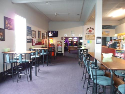 a dining room with tables and chairs in a restaurant at Essex Arms in Huntly
