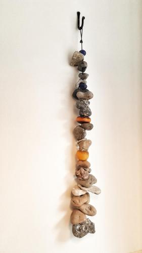 a group of rocks on a wall with a hook at Lundsbrunn B&B in Lundsbrunn