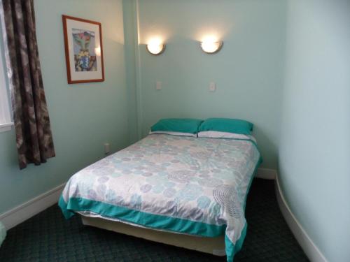 a small bedroom with a bed in a room at Essex Arms in Huntly