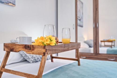 a wooden table with two glasses of orange juice on it at Apartments Meštrović with heated swiming pool- near Split in Kaštela
