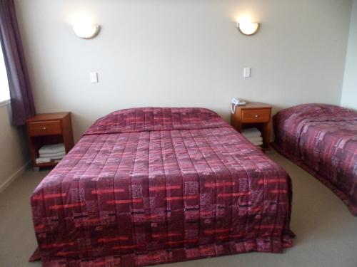 a bedroom with two beds and two night stands at Essex Arms in Huntly