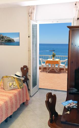 a bedroom with a bed and a view of the ocean at Hotel La Gondola in Ischia