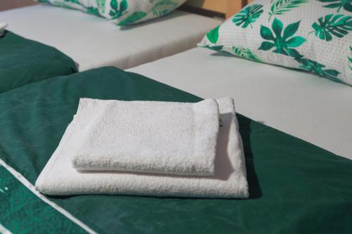 a white towel sitting on top of a bed at Apartment Mihajlovic in Vranje