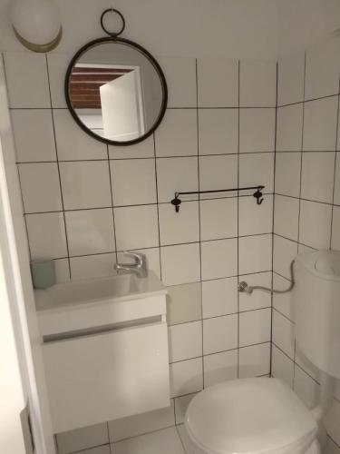 a bathroom with a toilet and a mirror at 5 minutes walk ART in Split