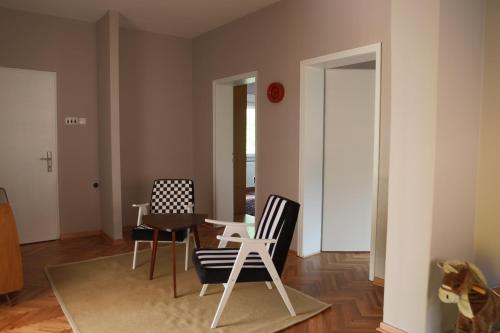 a living room with two chairs and a table at Apartment Mihajlovic in Vranje