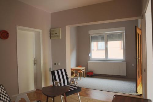 a living room with a table and chairs and a window at Apartment Mihajlovic in Vranje