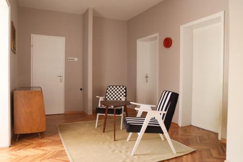 a living room with two chairs and a table at Apartment Mihajlovic in Vranje