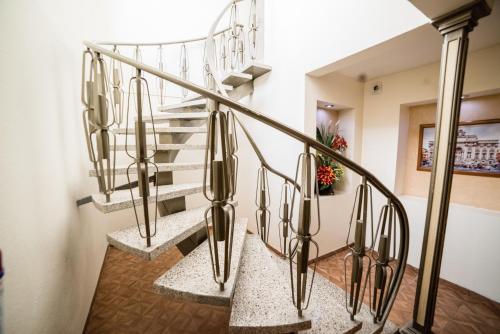 a set of stairs with metal railings in a house at Hotel Elizabeth Central in Aguascalientes