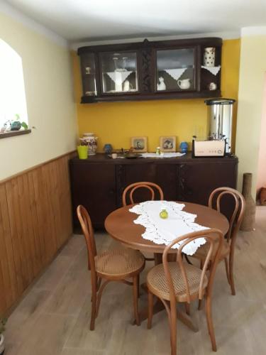 a kitchen with a table and chairs in a room at Dworska Zagroda in Korytowo