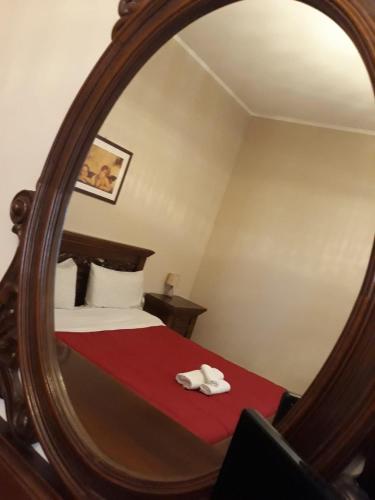 a bedroom with a bed with a large mirror at Country House Paola in Marina di Gioiosa Ionica